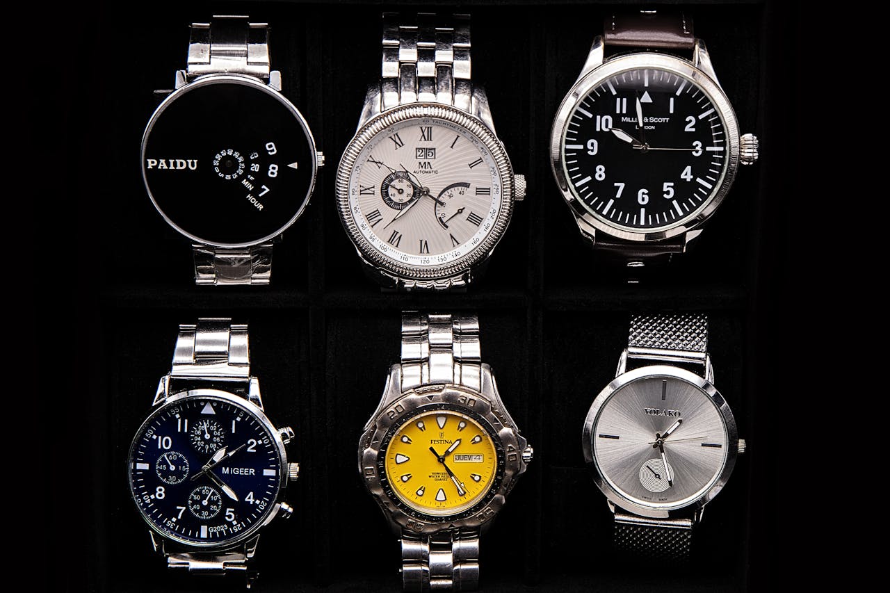 A variety of sophisticated wristwatches displayed against a dark background.